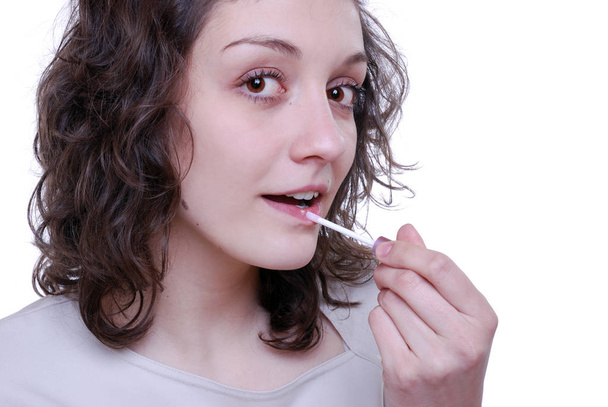 young woman with a toothbrush on a white background - Foto, Imagen