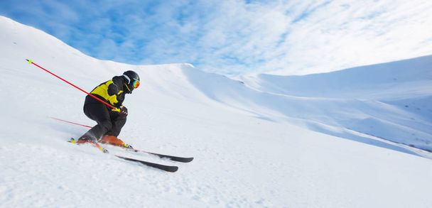 Alpine skier skiing in mountains - Photo, Image