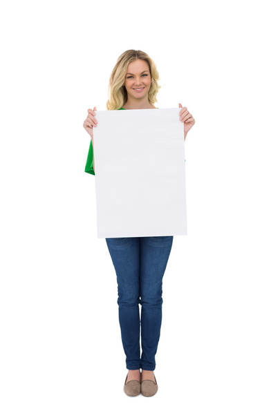 Smiling cute blonde holding white sign - Foto, Imagen