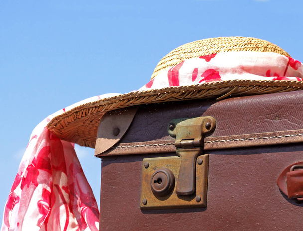 old suitcase with a hat and a bag on the beach - Photo, image