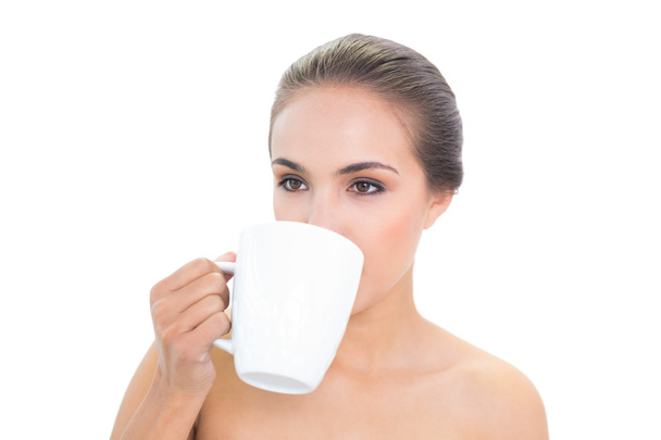 Lovely young woman drinking out of a mug - Foto, immagini