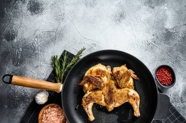 Grilled chicken with pepper and rosemary. Gray background. Top view. Space for text - Фото, зображення