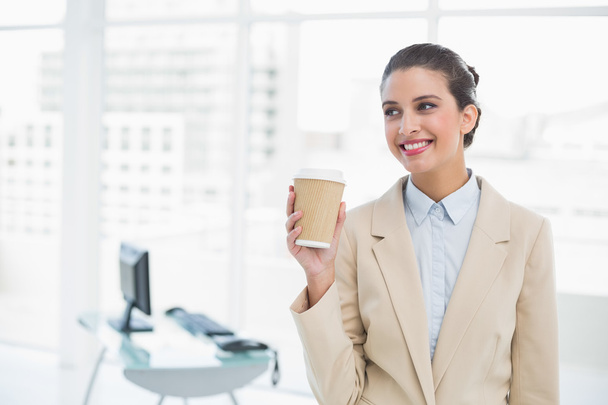 Cheerful businesswoman holding a cup of coffee - Zdjęcie, obraz