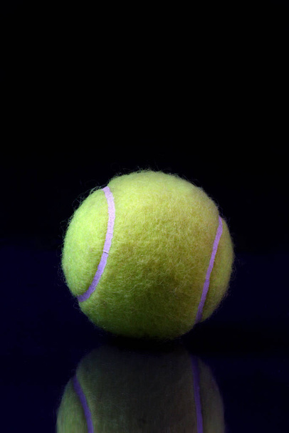 Tennis ball on black background - Fotoğraf, Görsel