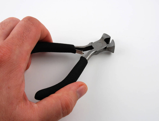 hand holding a hammer on a white background - Foto, Imagen