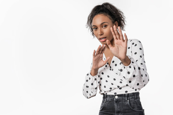 Young african american woman afraid and terrified with fear expression stop gesture with hands standing over isolated white background - Fotoğraf, Görsel