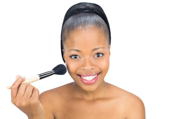 Woman using a makeup brush - Fotó, kép