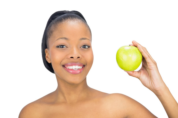 Приваблива жінка тримає зелене яблуко
 - Фото, зображення