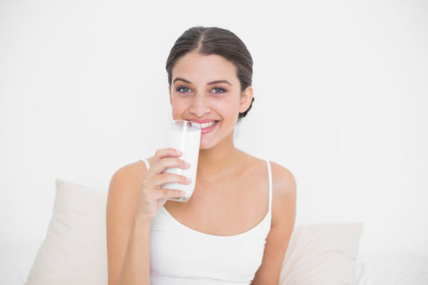 Model in white pajamas drinking milk - Foto, Imagem