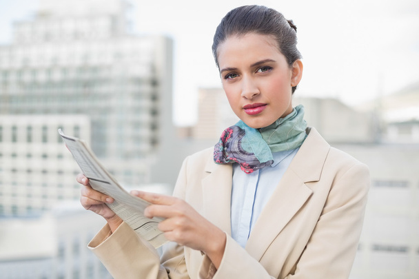 Serious businesswoman holding a newspaper - Photo, Image