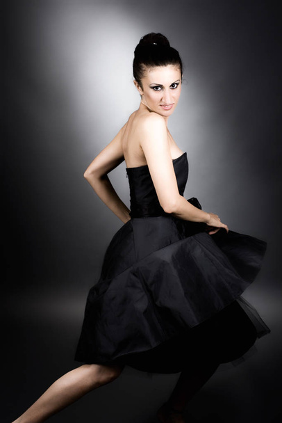 beautiful woman in black dress with a bow tie - Foto, afbeelding