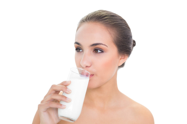 Lovely woman drinking a glass of milk - 写真・画像