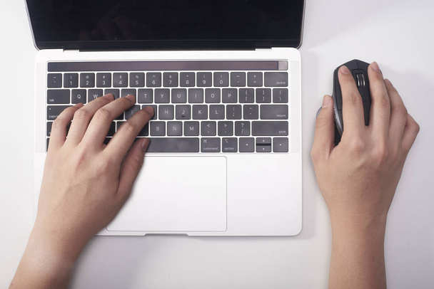 A business person is using a laptop and a mouse - Fotó, kép
