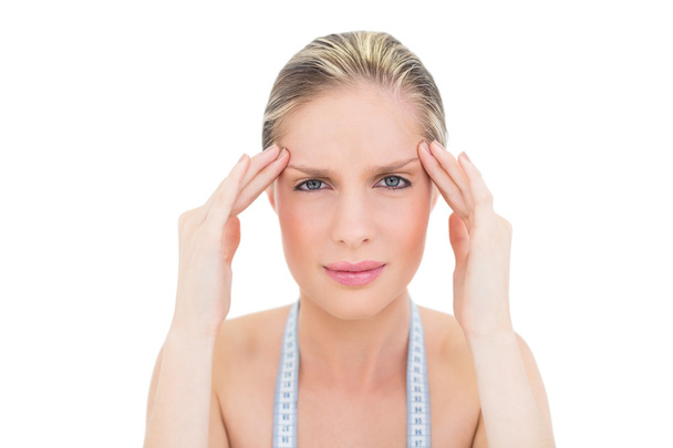 Frowning fresh blonde woman suffering from headache - Photo, image