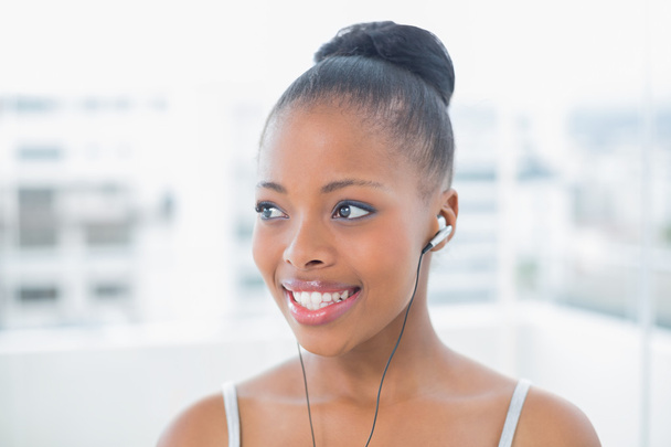 Cheerful woman in sportswear listening to music - Photo, Image