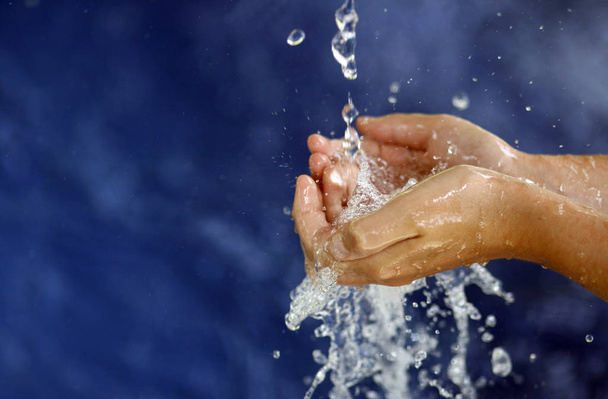woman splashing water in the air - Φωτογραφία, εικόνα