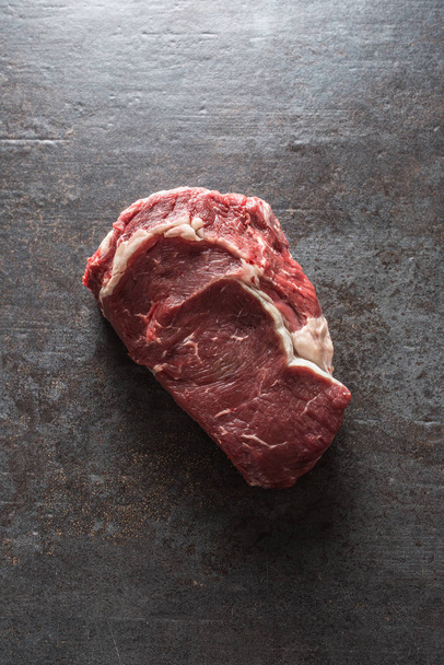 Beef Rib Eye steak on slate board - Top of view - Photo, image
