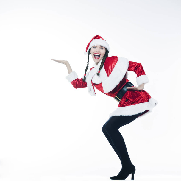 beautiful young woman in santa claus costume dancing isolated on white background - Foto, immagini
