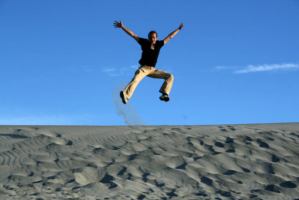 man jumping on desert - 写真・画像
