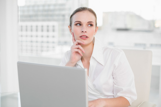Thoughtful businesswoman using laptop - Фото, изображение