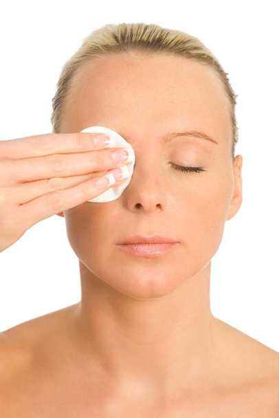 young woman applying cosmetic cream on face - Foto, immagini