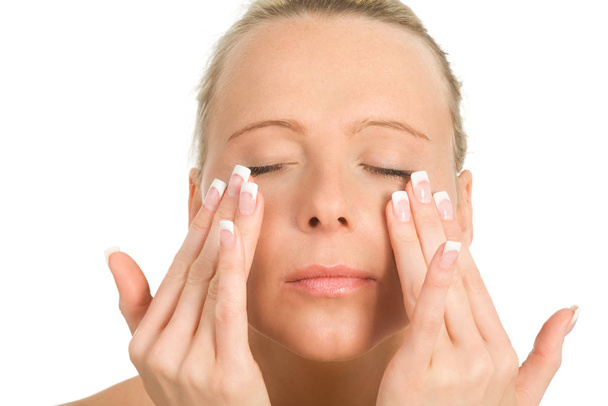 young woman applying cosmetic cream on her face - Фото, зображення