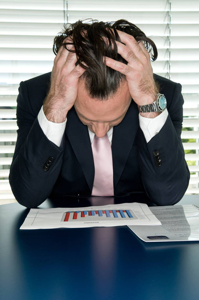 üzletember fejfájással a munkahelyen - Fotó, kép