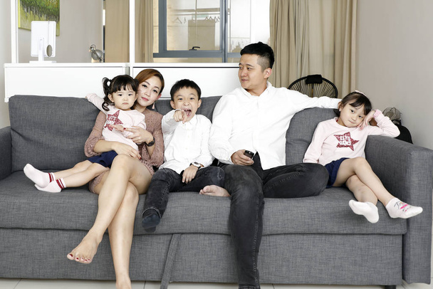 Parents Child Family father mother daughter son sit on sofa watc - Photo, Image