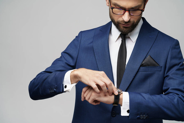 studio shot stylish businessman wearing suit and watches - Fotó, kép
