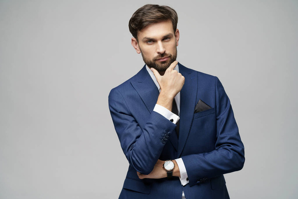 Studuo shot of thinking businessman wearing suit - Fotografie, Obrázek