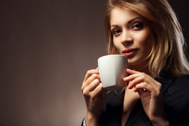 Beautiful Girl Drinking Tea or Coffee - 写真・画像