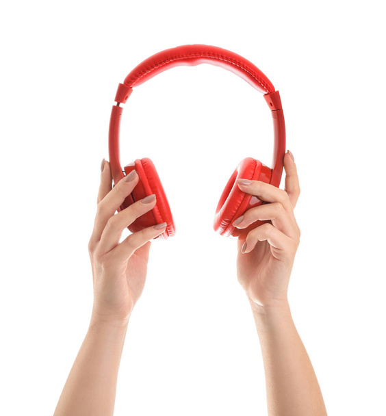 Hands with modern headphones on white background - 写真・画像