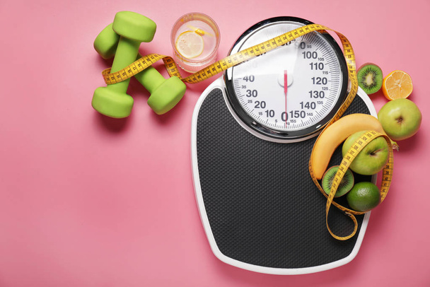 Different healthy food with measuring tape, scales and dumbbells on color background. Diet concept - Fotoğraf, Görsel