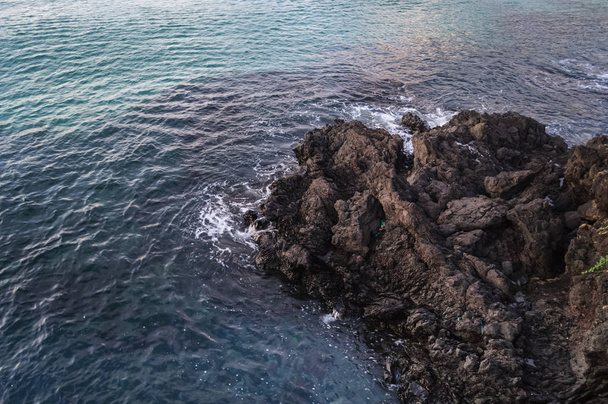 sea with lava rocks on Jeju - Φωτογραφία, εικόνα