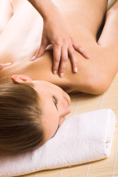 young woman receiving back massage in spa - Zdjęcie, obraz