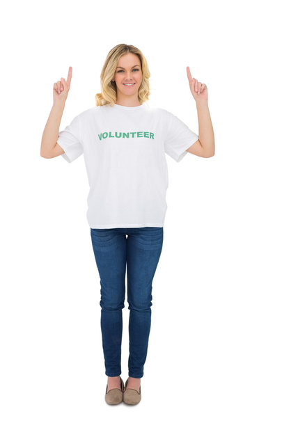 Smiling blonde volunteer pointing up - Photo, Image