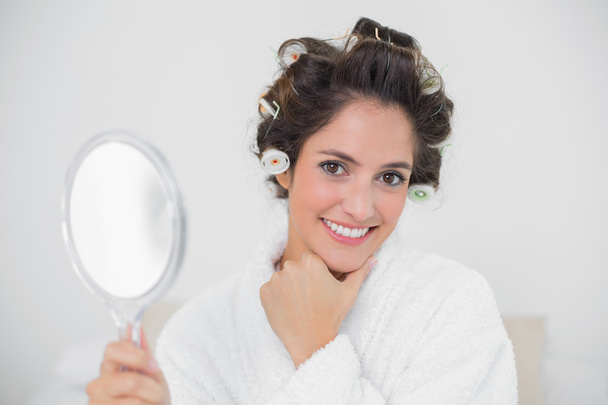 Gleeful natural brunette holding hand mirror - Foto, afbeelding