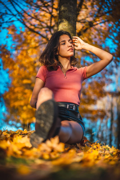 sunset portrait of beautiful young woman in autumn park - Фото, зображення