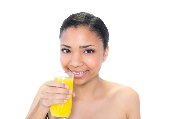Happy young model drinking orange juice - Foto, imagen