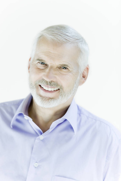 portrait of expressive old senior man in blue shirt on white background - Fotoğraf, Görsel