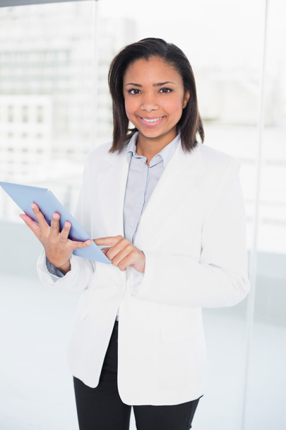 Pleased young businesswoman using a tablet pc - Fotoğraf, Görsel