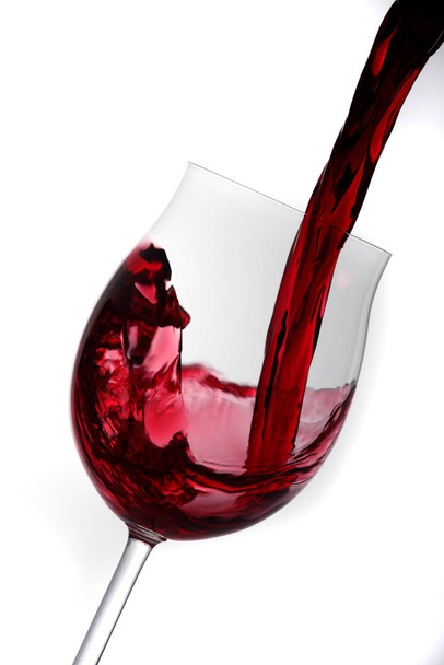 red wine pouring into glass - Фото, зображення