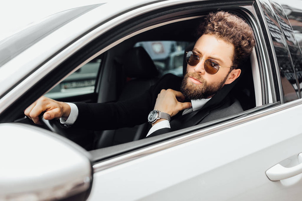 Handsome young businessman driving car, selective focus - Foto, Imagem