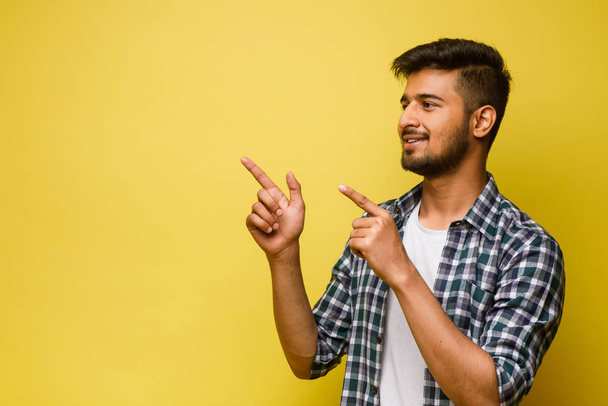 Young handsome man on yellow background - Foto, immagini
