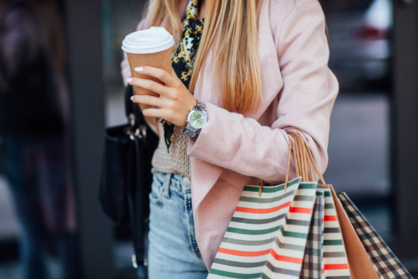 Beautiful young blonde woman with shopping bags, selective focus - Fotoğraf, Görsel