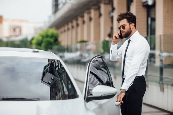 Handsome young businessman near new white car, selective focus - Photo, Image