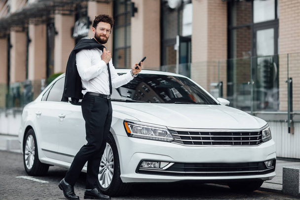 Handsome young businessman near new white car, selective focus - Zdjęcie, obraz