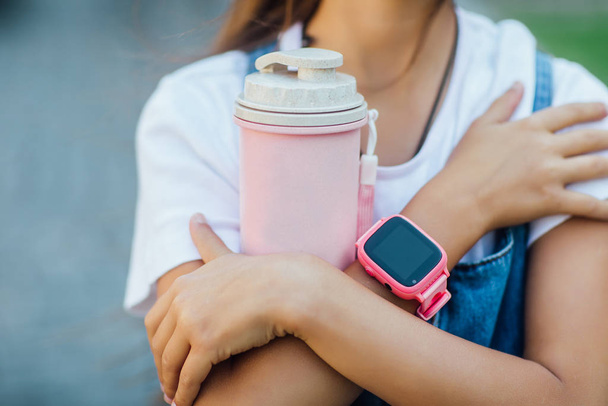 girl with smartwatch on fresh air, selective focus - Foto, afbeelding