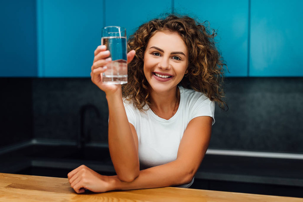 Beautiful happy woman sitting with water at home - Photo, image
