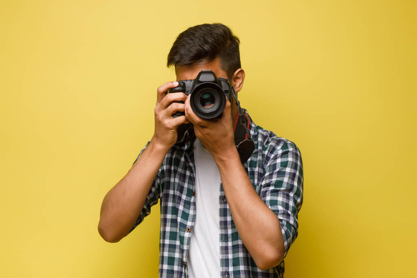 Young handsome man on yellow background - Valokuva, kuva